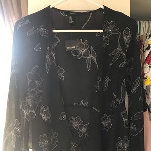 A wrap style long sleeve black & white shirt